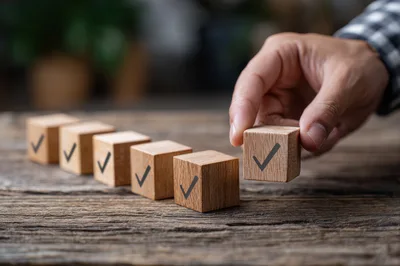 Hand Placing Wooden Block With Checkmark Symbol