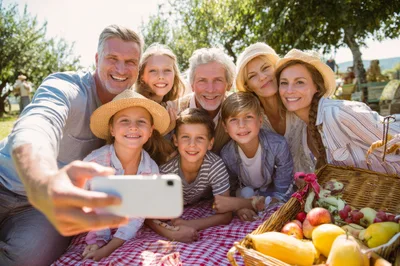 Multi-Generational Family Taking A Selfie At A Picnic