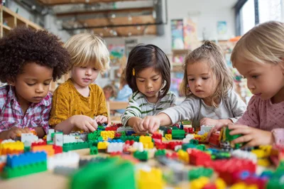 Diverse Preschool Children Playing Together With Colorful Building Blocks
