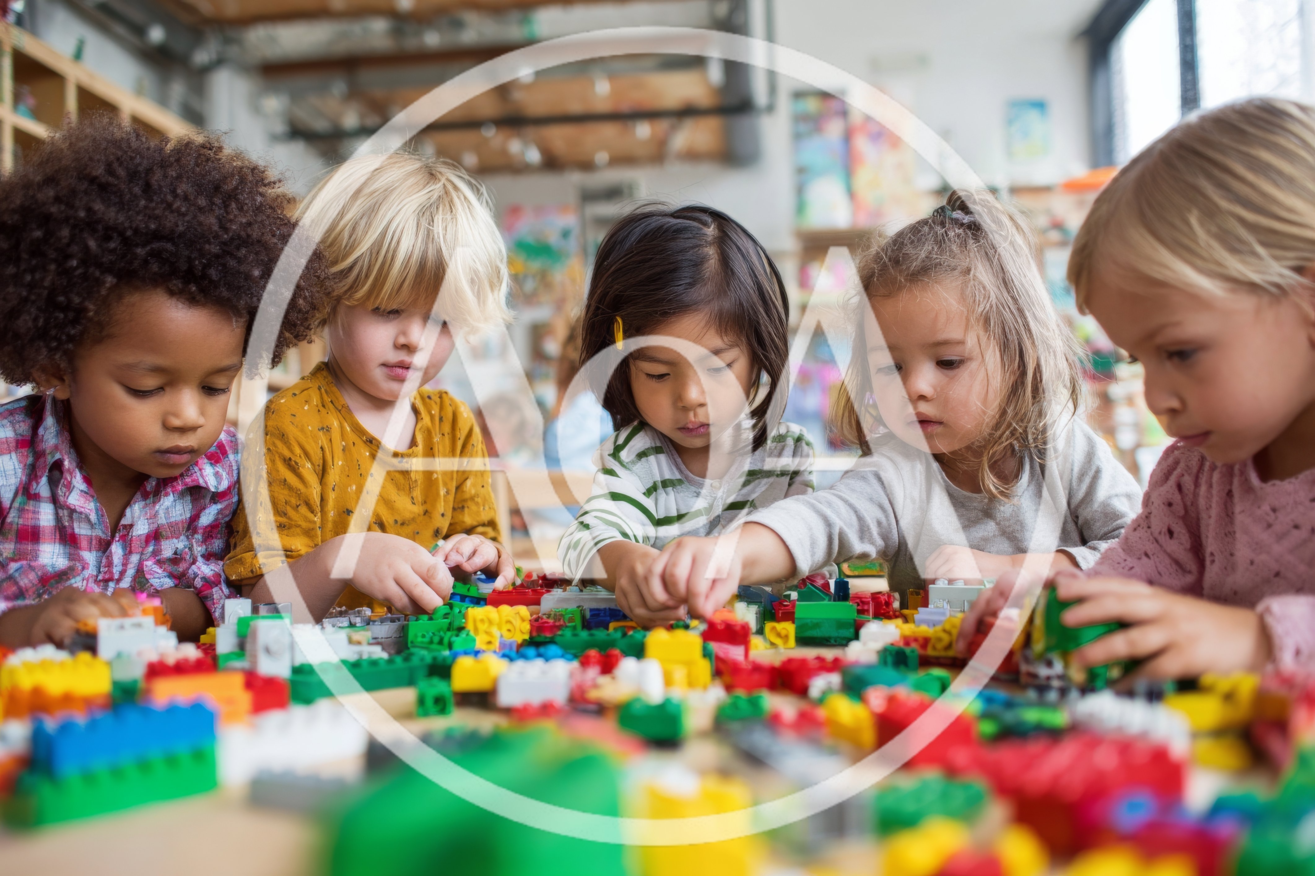 Diverse Preschool Children Playing Together With Colorful Building Blocks