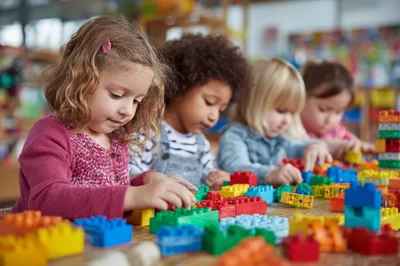 Diverse Preschool Children Playing With Colorful Building Blocks