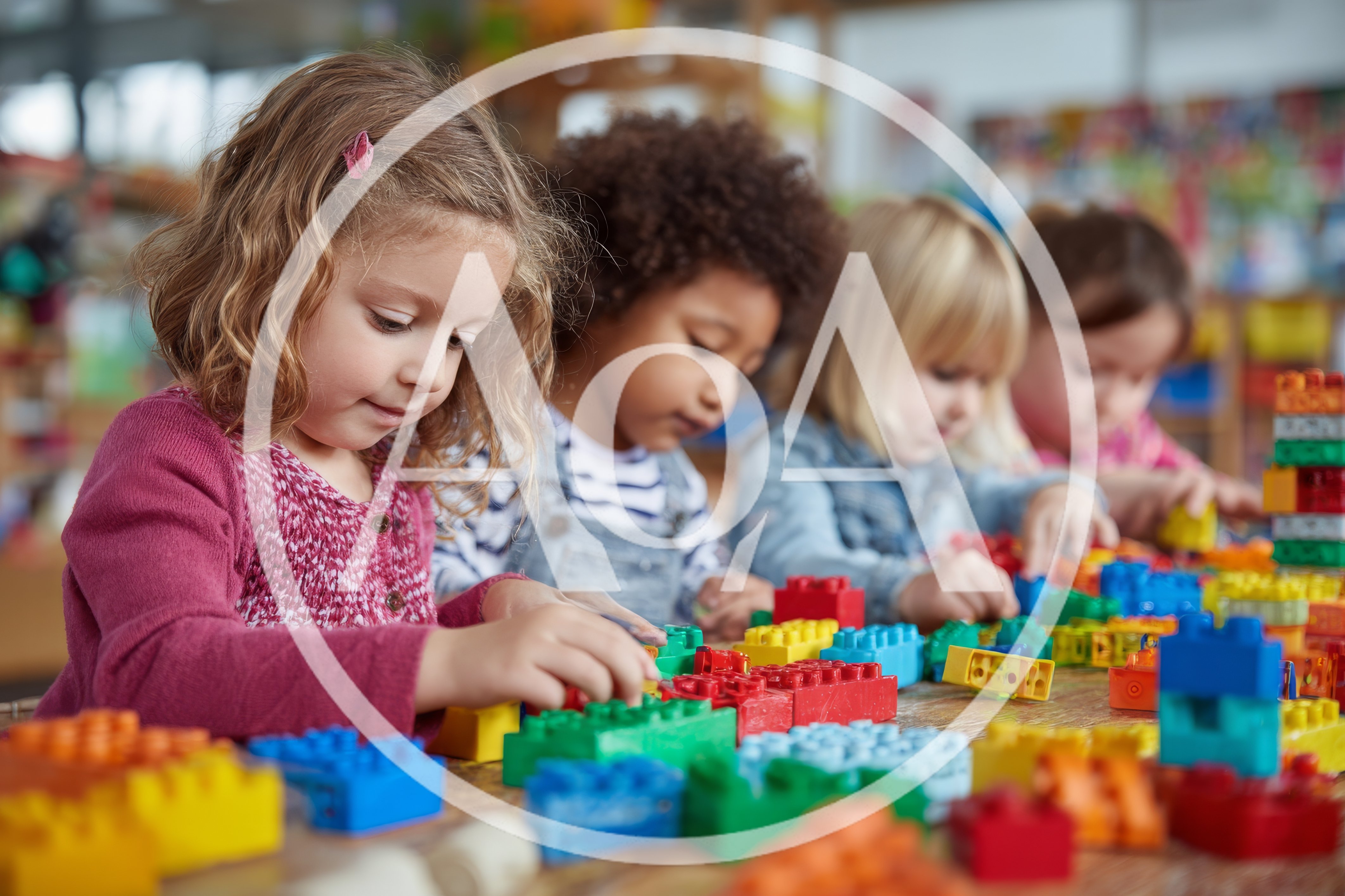 Diverse Preschool Children Playing With Colorful Building Blocks