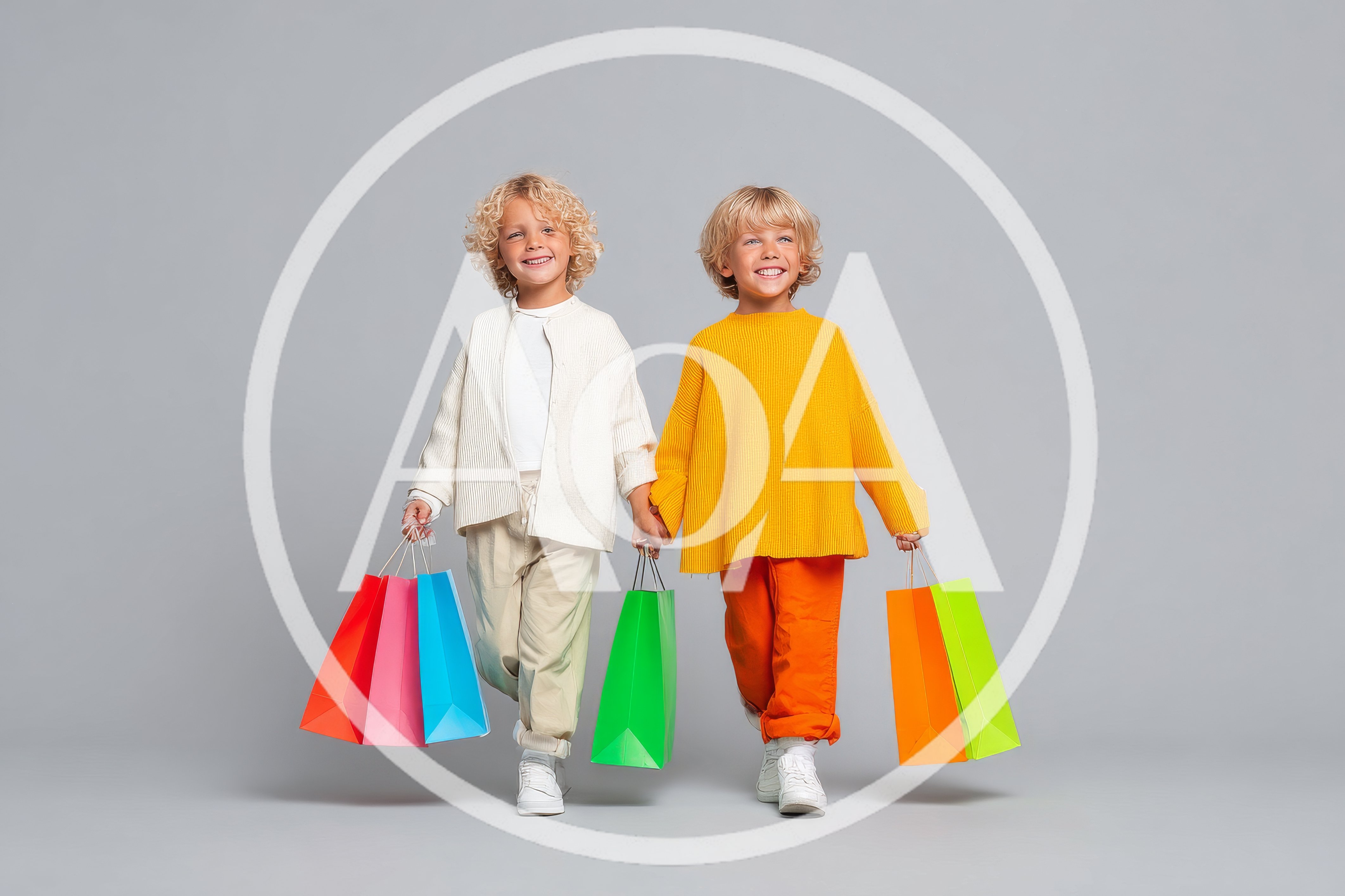 Two Happy Children Holding Colorful Shopping Bags