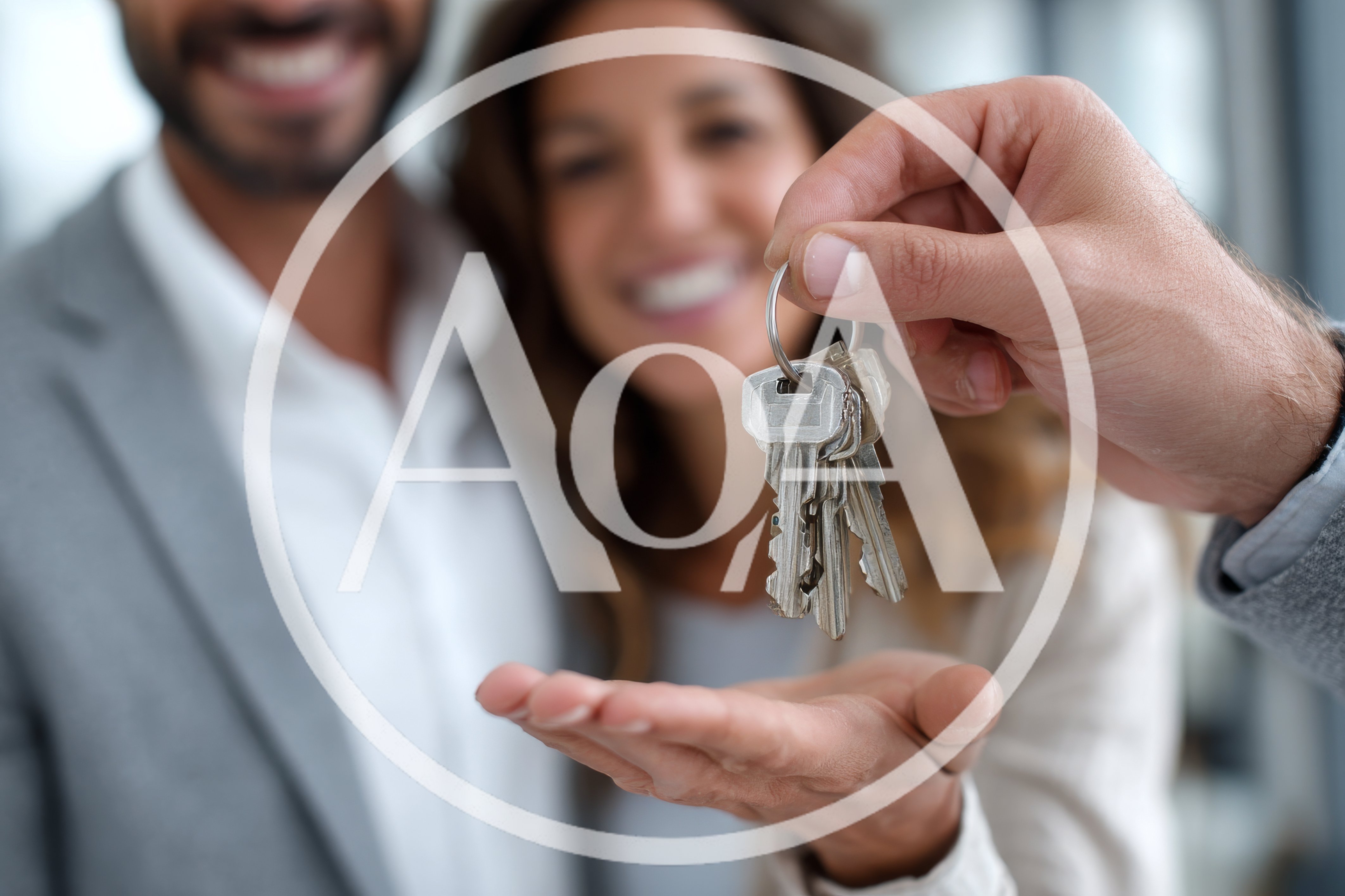 Real Estate Agent Handing Over House Keys To Couple