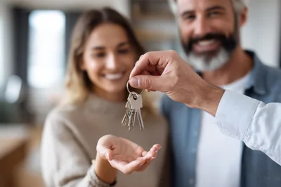 Man Handing Over House Keys To A Woman