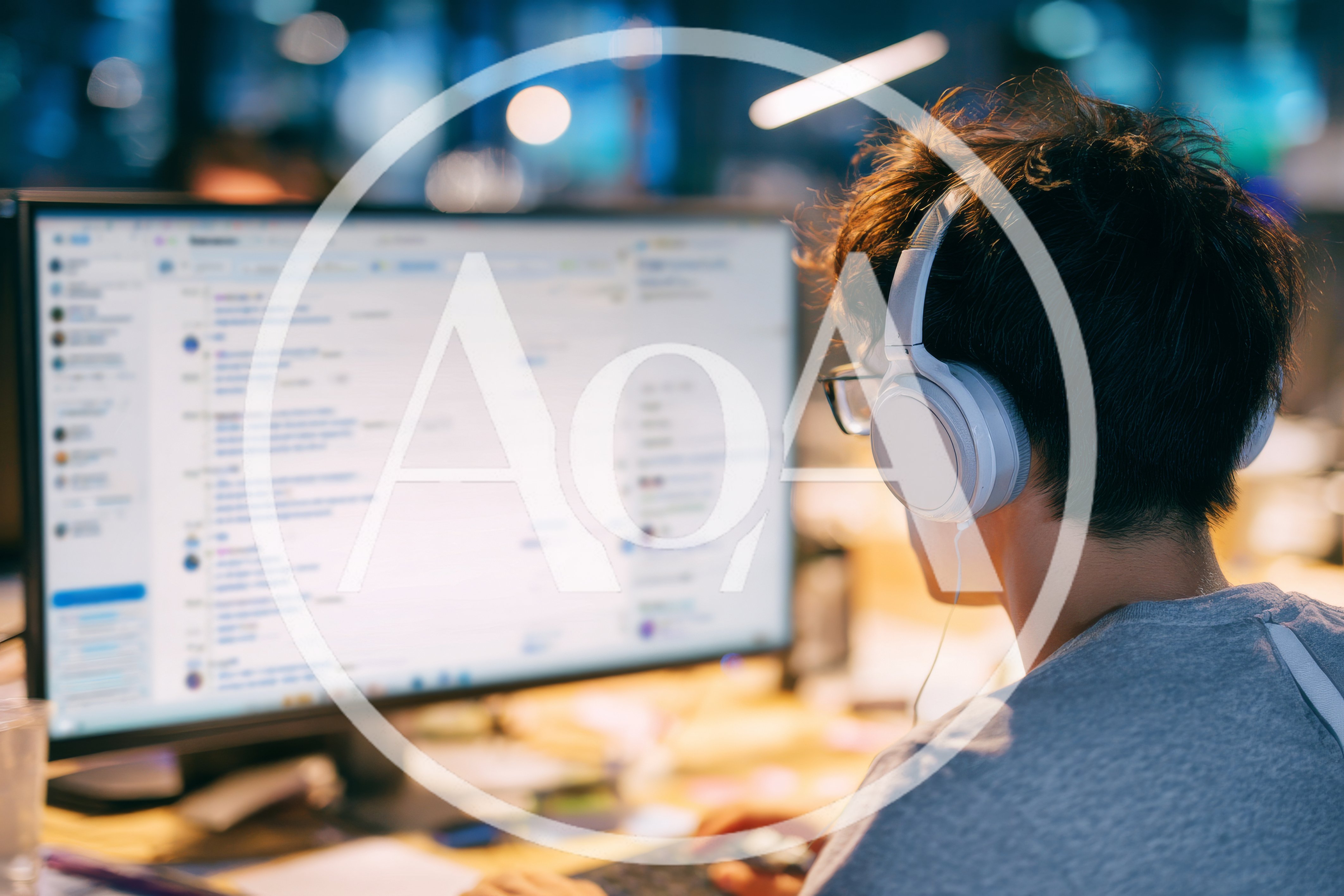 Young Man Working On Computer With Headphones