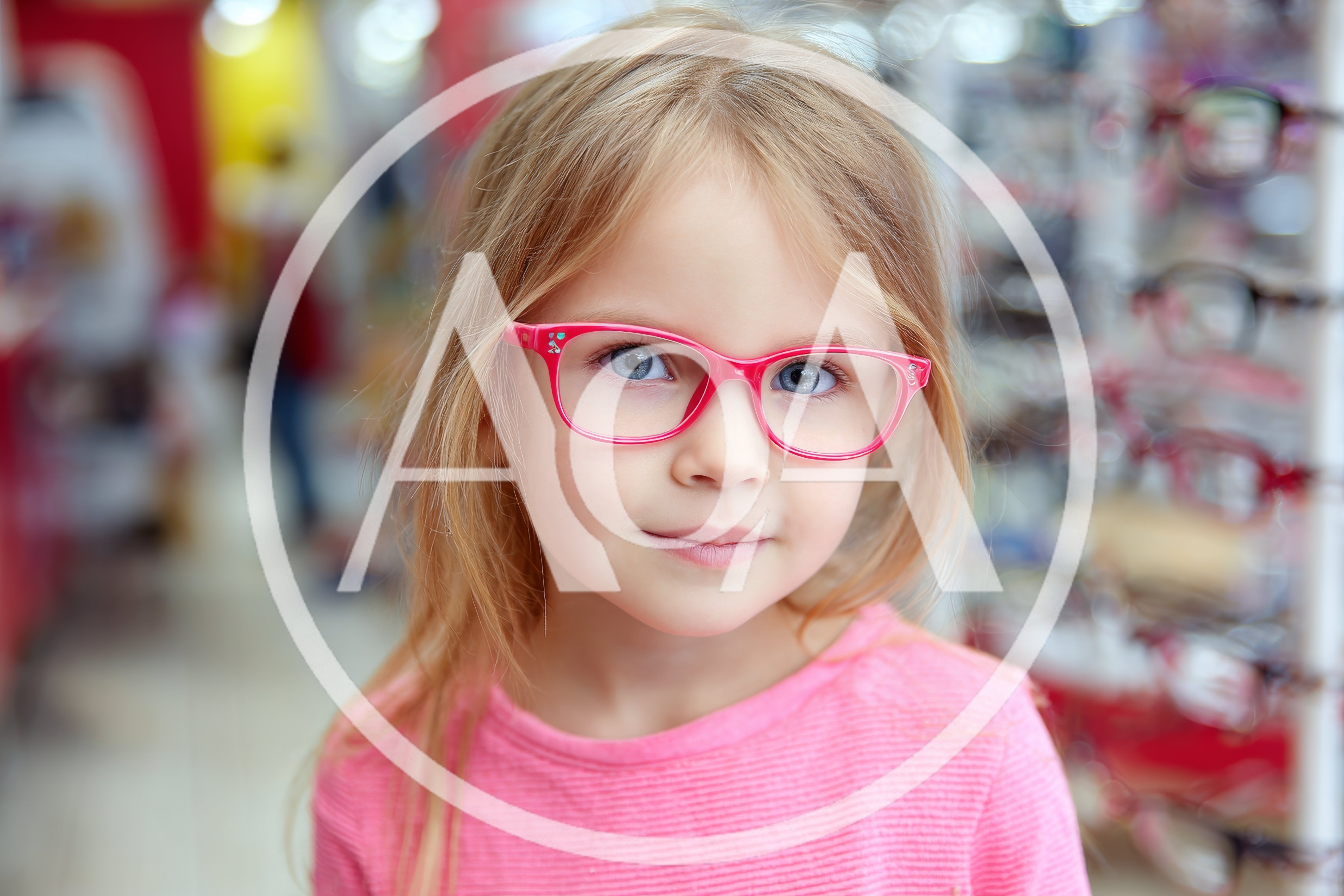 Little Girl Trying On Pink Glasses In Optical Store