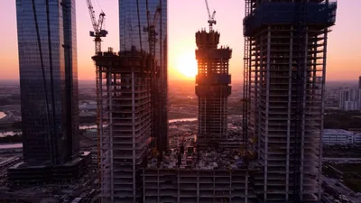 Aerial View of Skyscraper Construction at Sunset