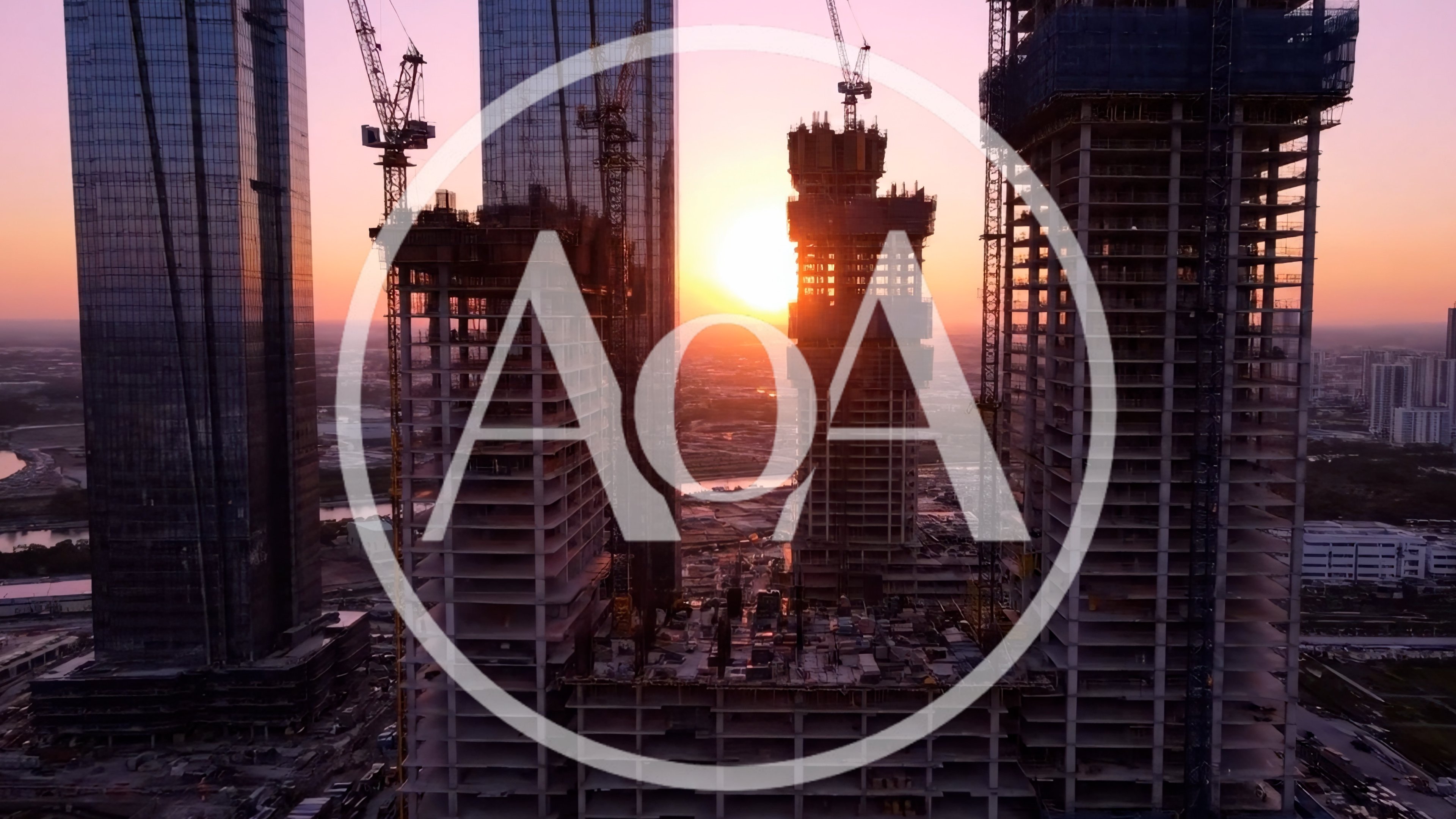 Aerial View of Skyscraper Construction at Sunset