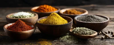 Assorted Spices In Wooden Bowls On Rustic Table