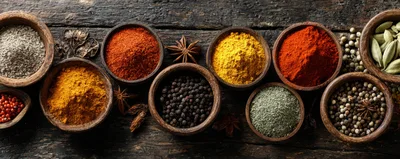 Assorted Spices In Wooden Bowls On Rustic Table
