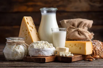 Assorted Dairy Products and Fresh Cheese on Wooden Table