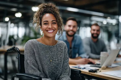 Smiling Woman In Wheelchair Working In Modern Office