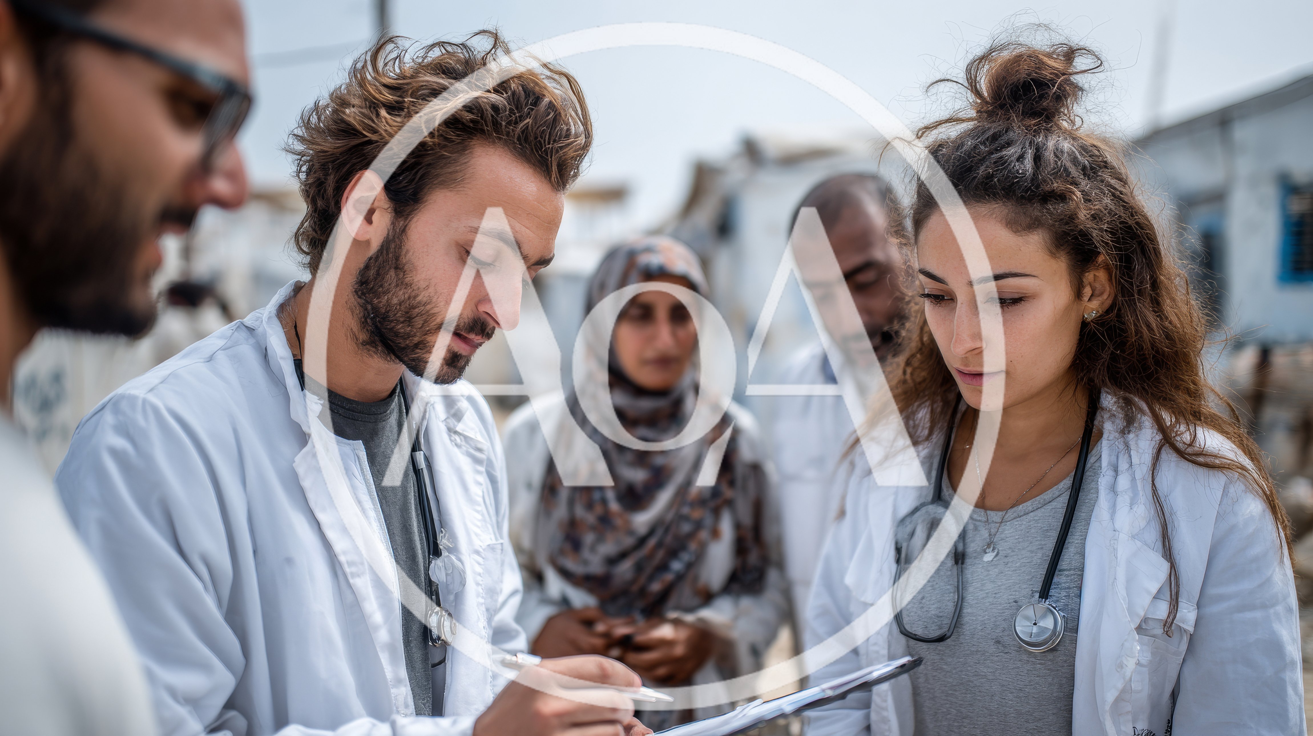 Medical Professionals Consulting With Patients In Refugee Camp