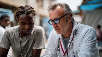 Doctor Consulting With Young Patient In Outdoor Setting