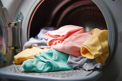 Colorful Laundry Inside An Open Clothes Dryer