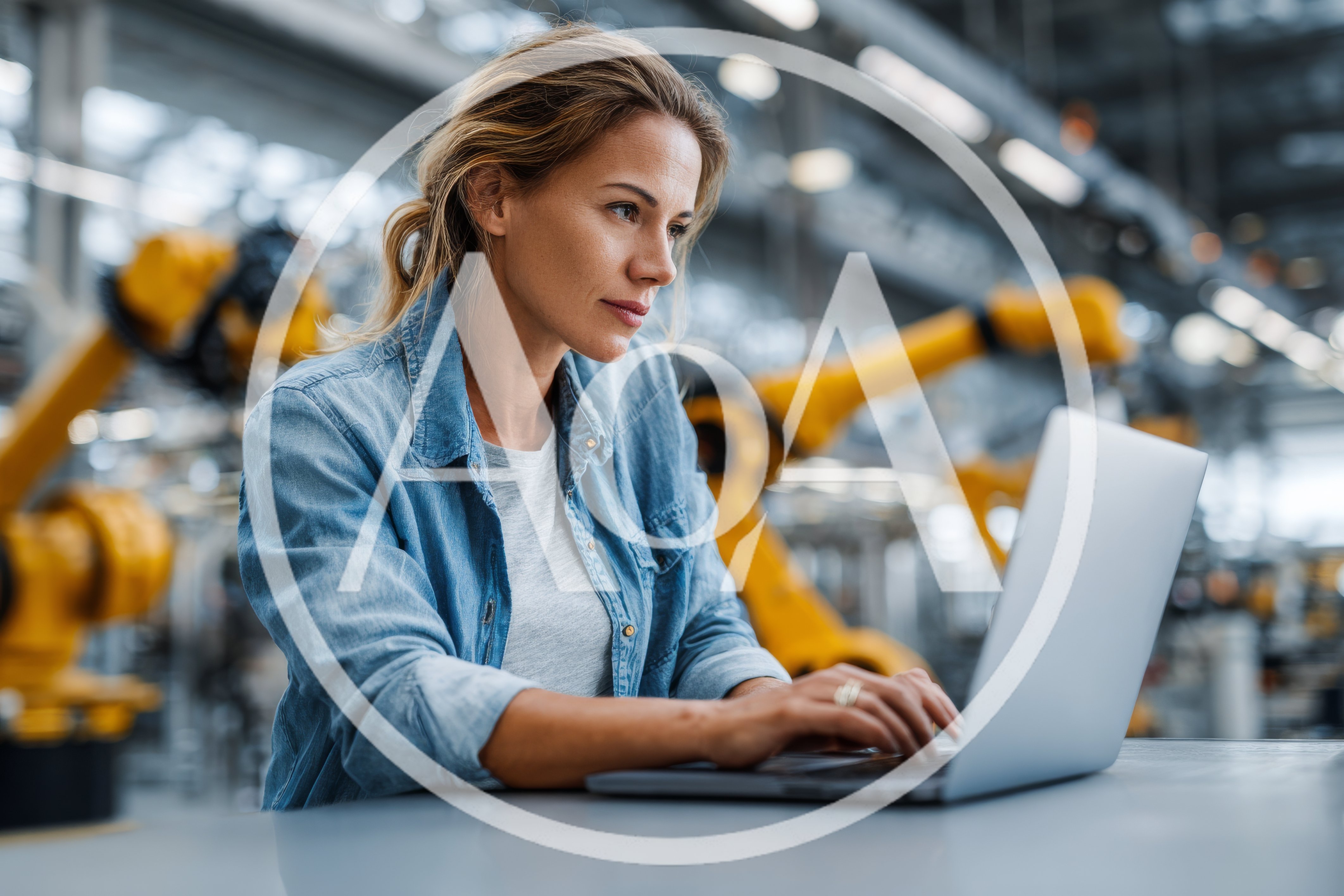 Female Engineer Working On Laptop In Automated Factory