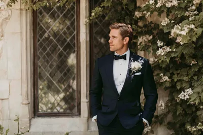 Handsome Groom Standing Outdoors In A Tuxedo