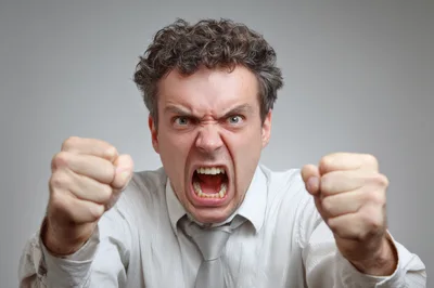 Angry Man Screaming With Clenched Fists