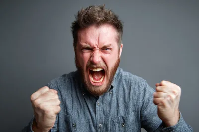 Angry Man Screaming With Clenched Fists
