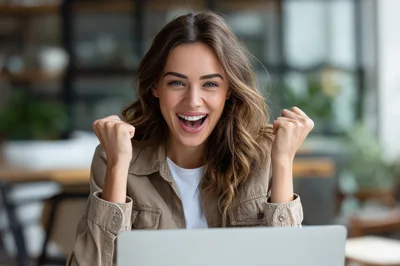 Excited Young Woman Celebrating Success At Her Laptop