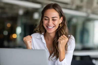 Excited Businesswoman Celebrating Success While Working On Laptop