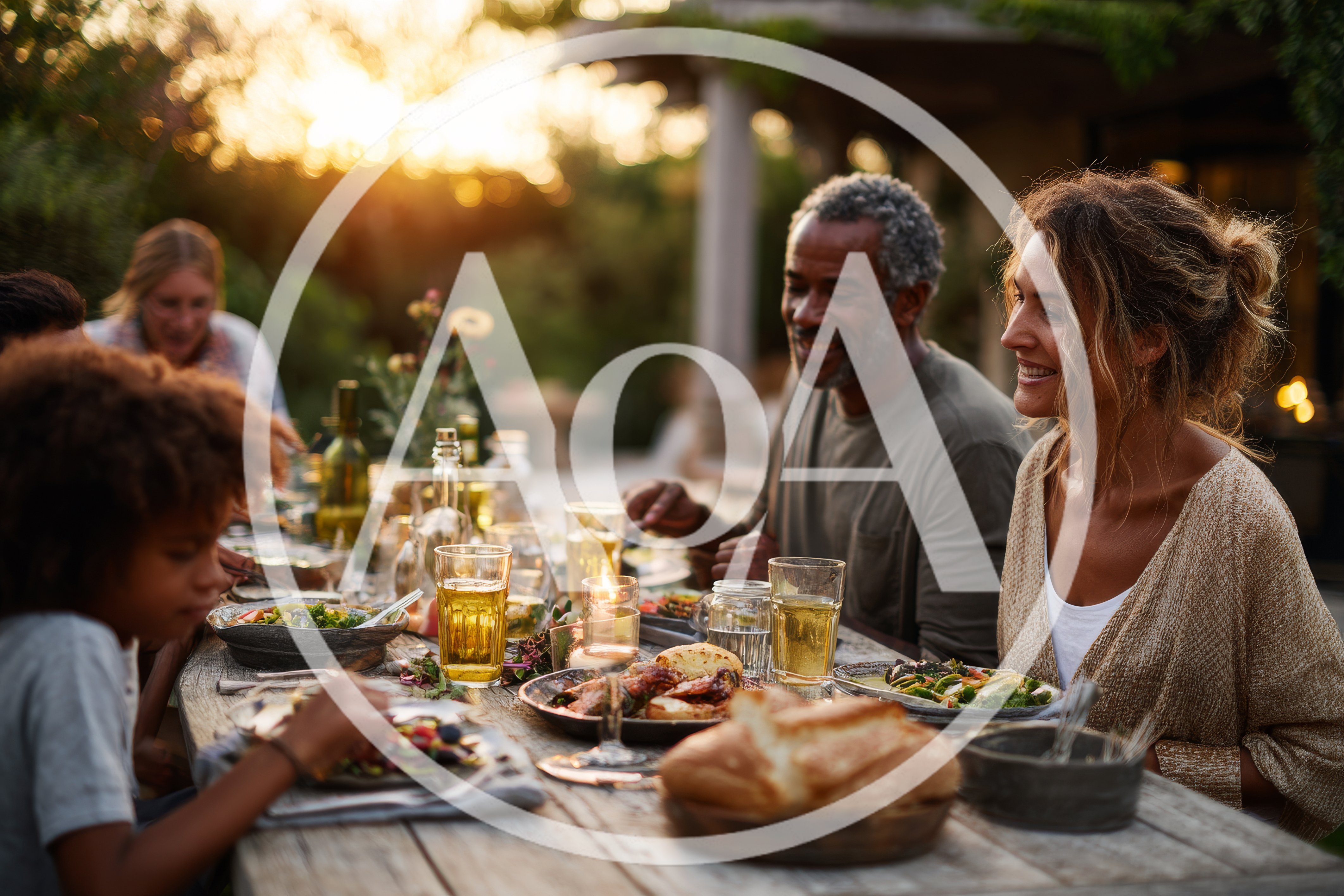Diverse Family Enjoying Outdoor Dinner At Sunset