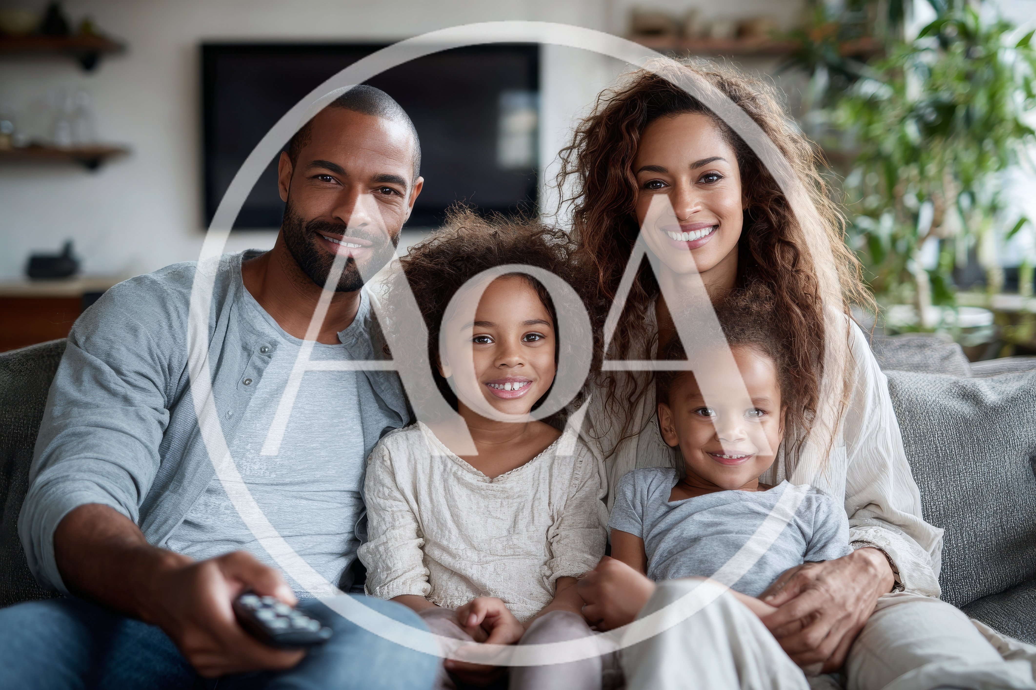 Happy Family Watching Television Together At Home