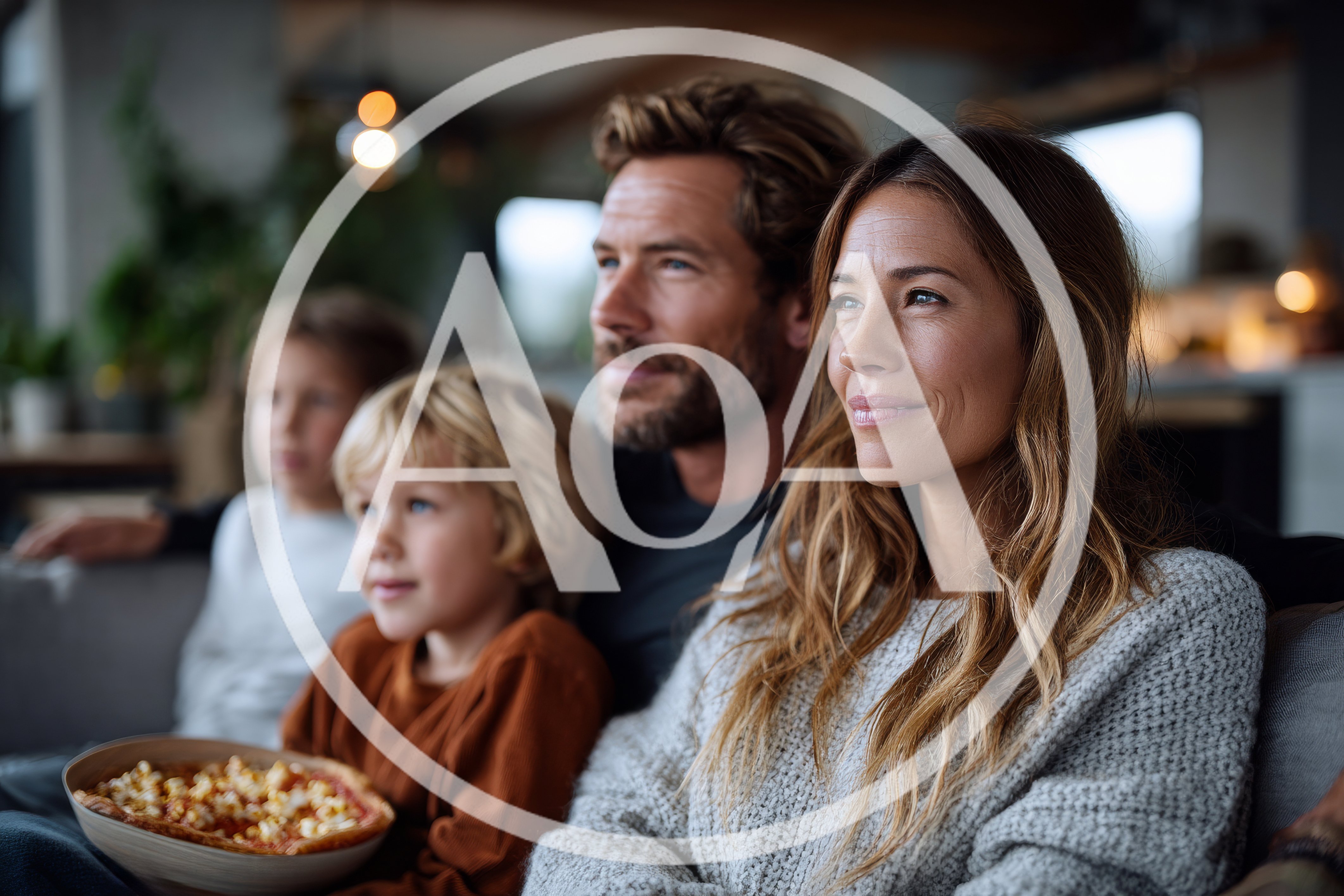 Family Watching Television Together In A Cozy Living Room