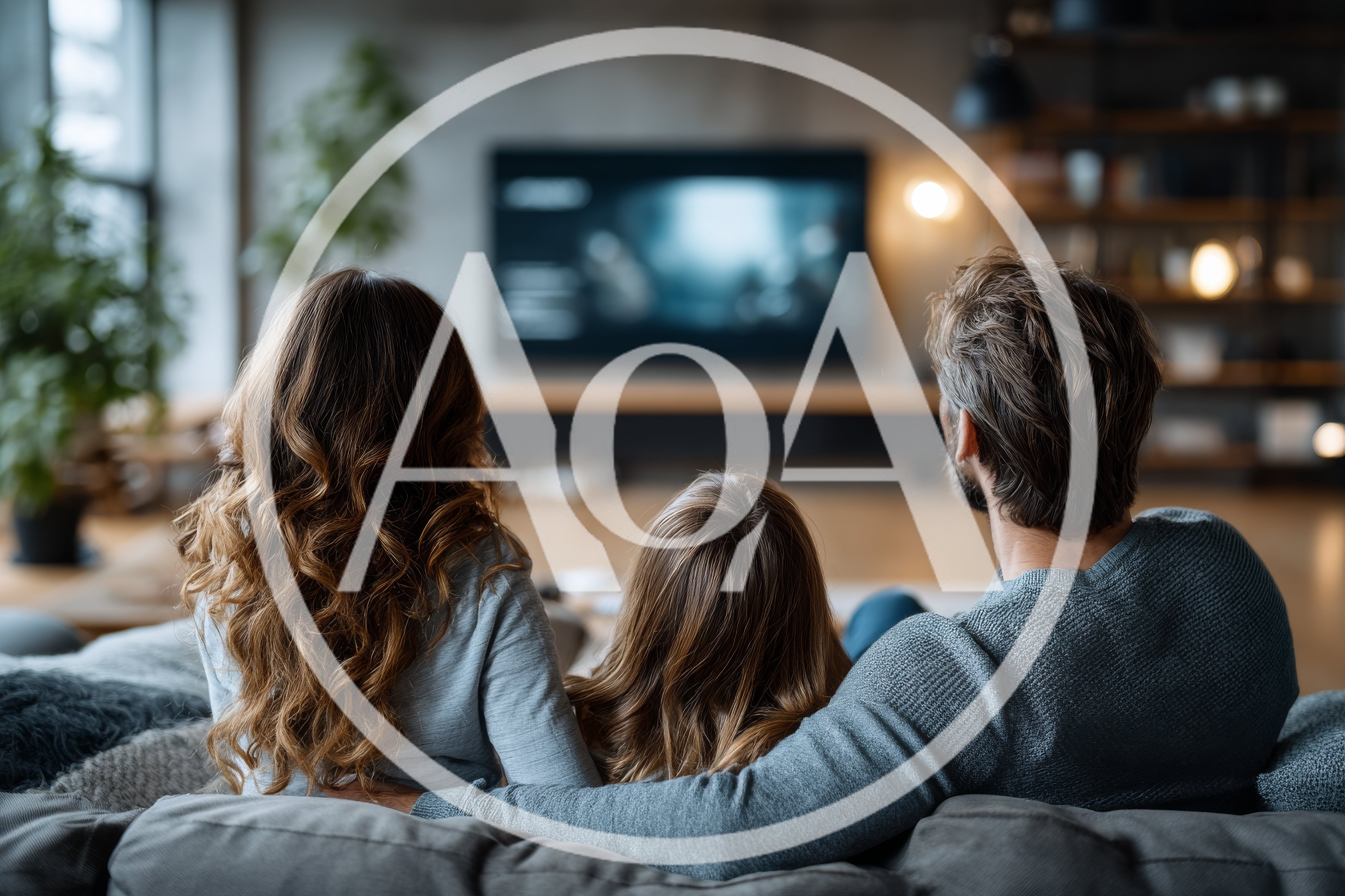 Family Watching Television Together In A Cozy Living Room