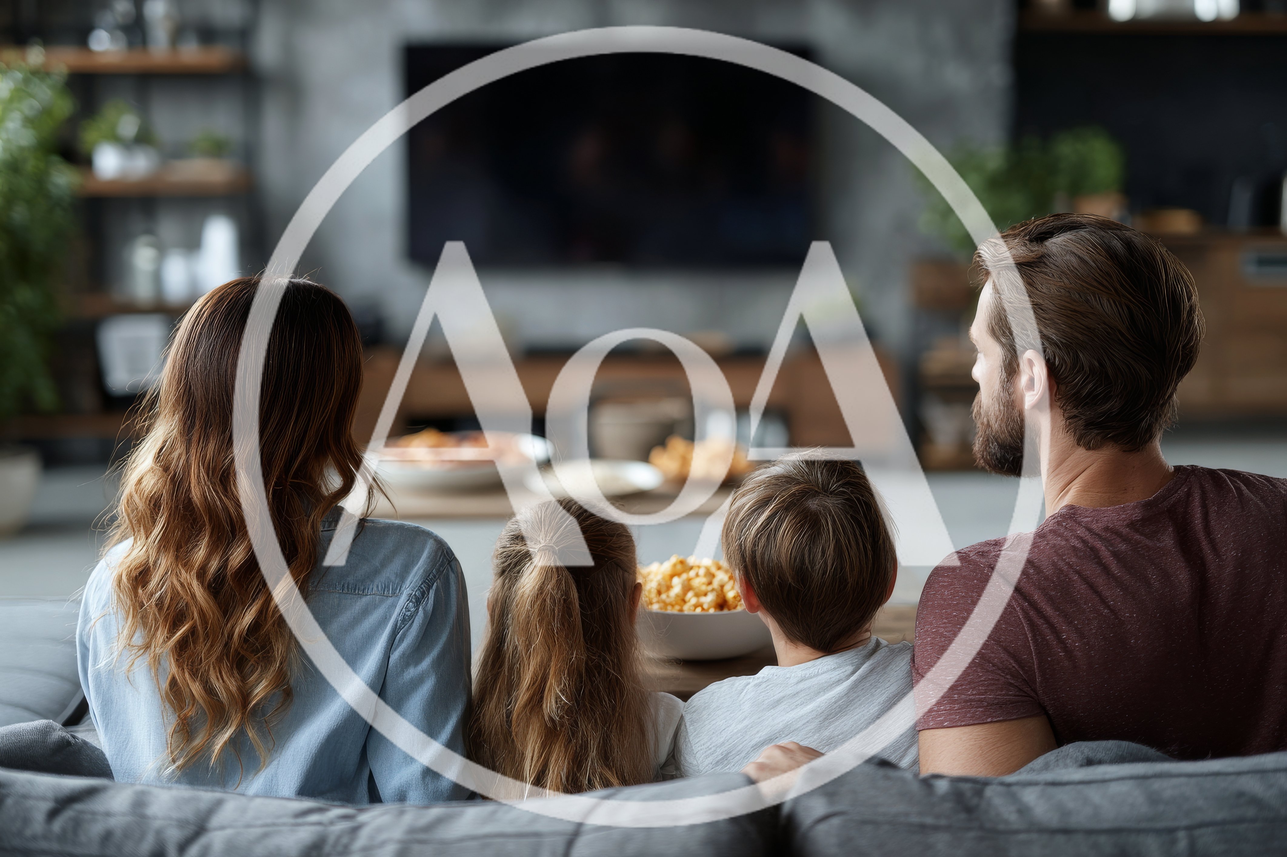 Family Watching Television Together In Living Room
