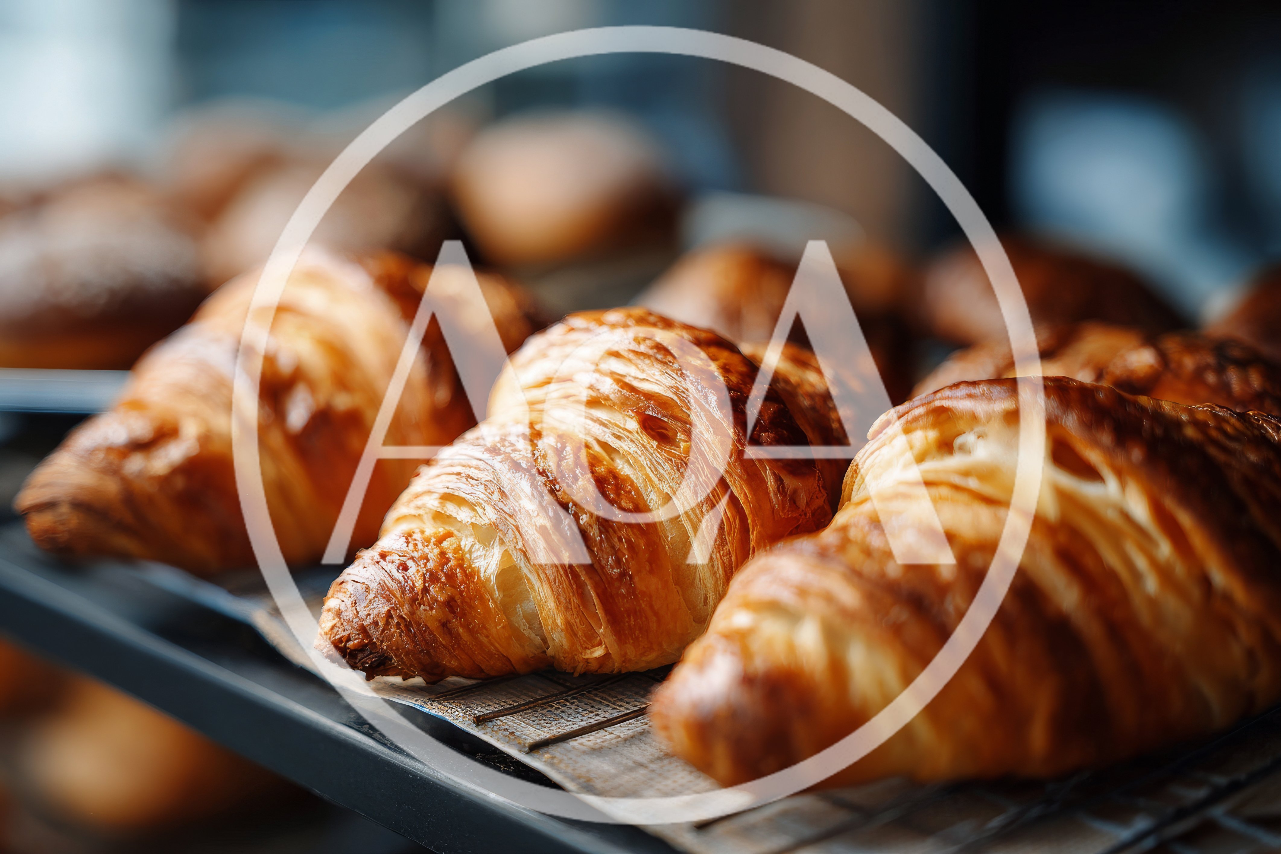 Freshly Baked Golden Croissants On A Bakery Rack