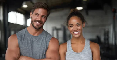 Fit Couple Smiling Together In A Modern Gym