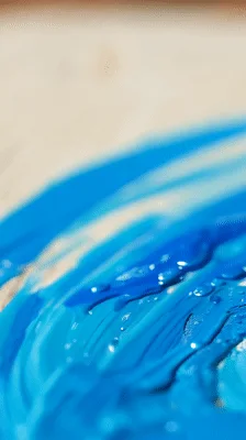 Artist Painting With Bright Blue Acrylic Paint