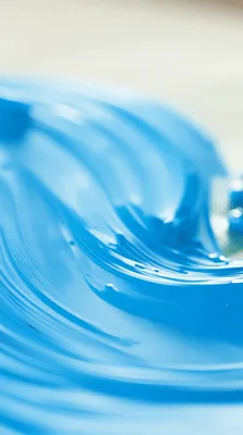 Artist Spreading Bright Blue Acrylic Paint On Canvas