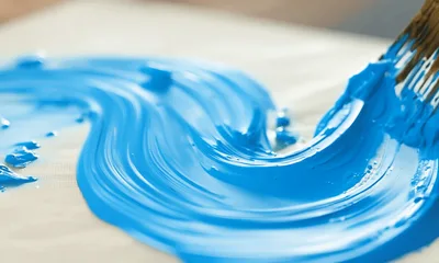 Artist Painting Blue Acrylic Swirls On Canvas
