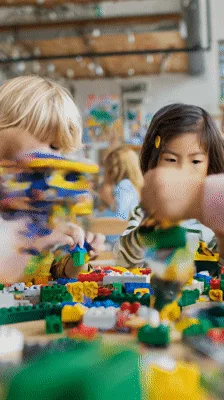 Diverse Preschool Children Building Together With Colorful Plastic Blocks