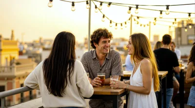 Friends Socializing With Drinks On A Rooftop Terrace