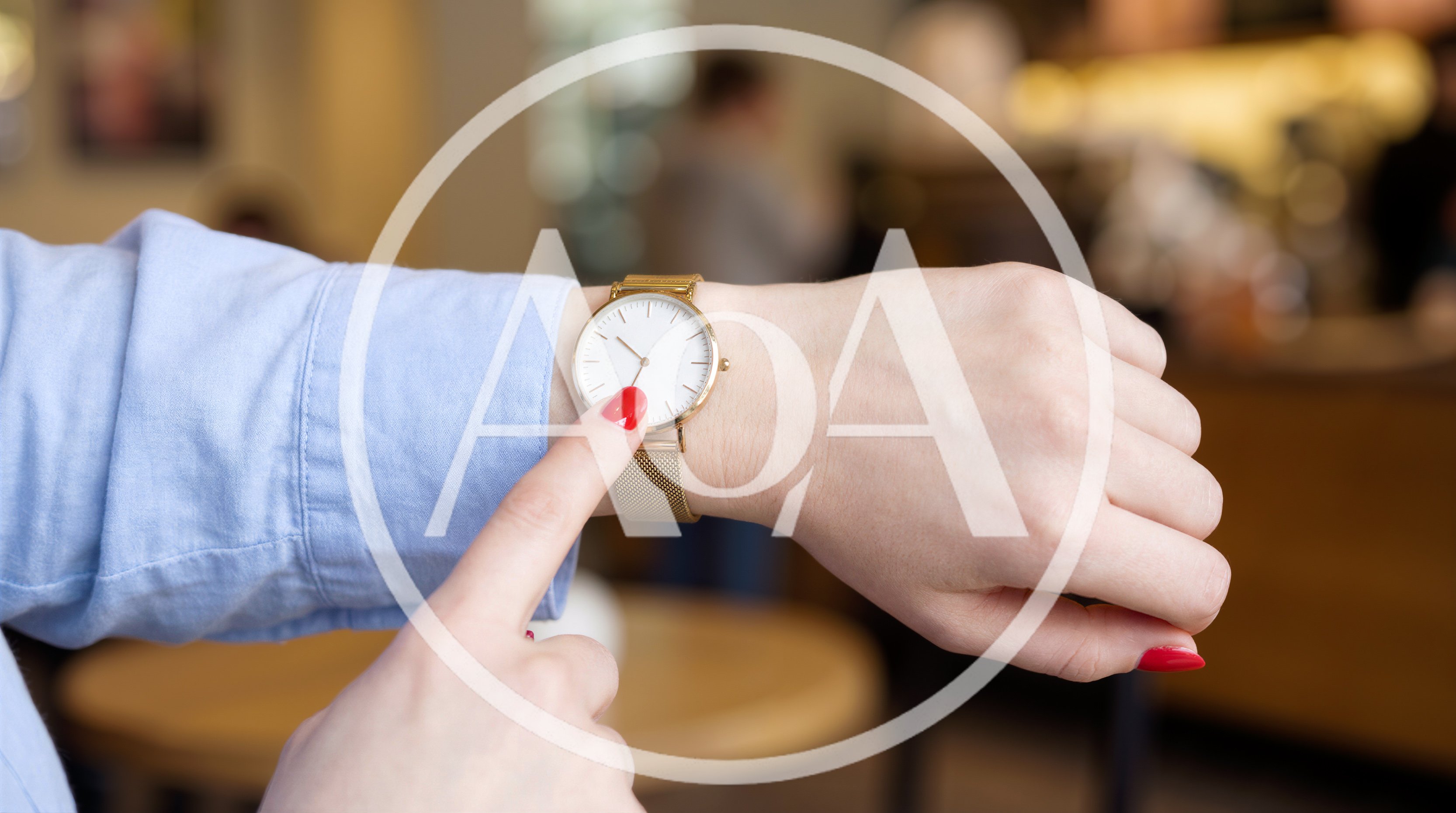 Woman Pointing At Her Gold Wristwatch