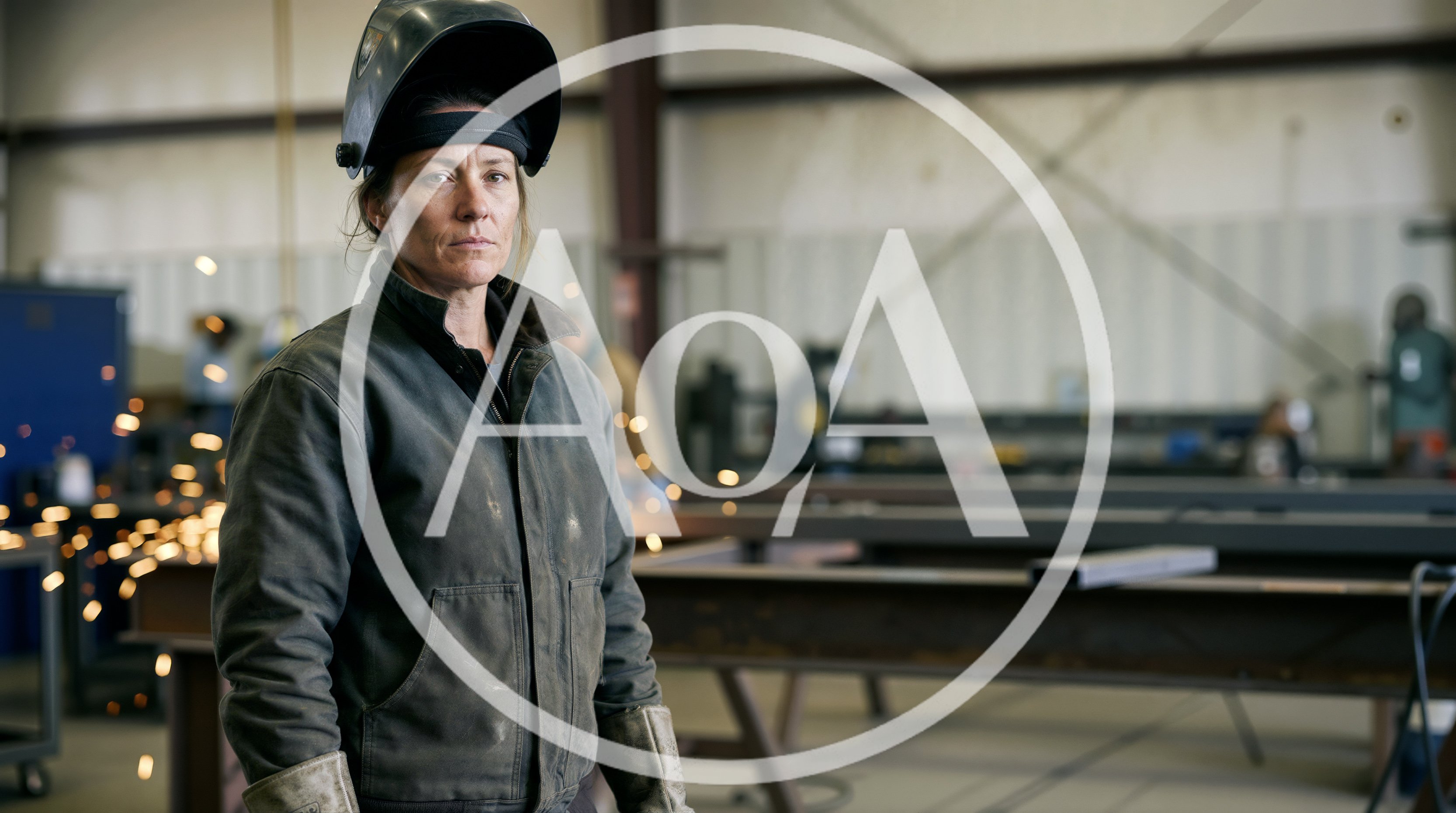 Female Welder Standing In Industrial Workshop