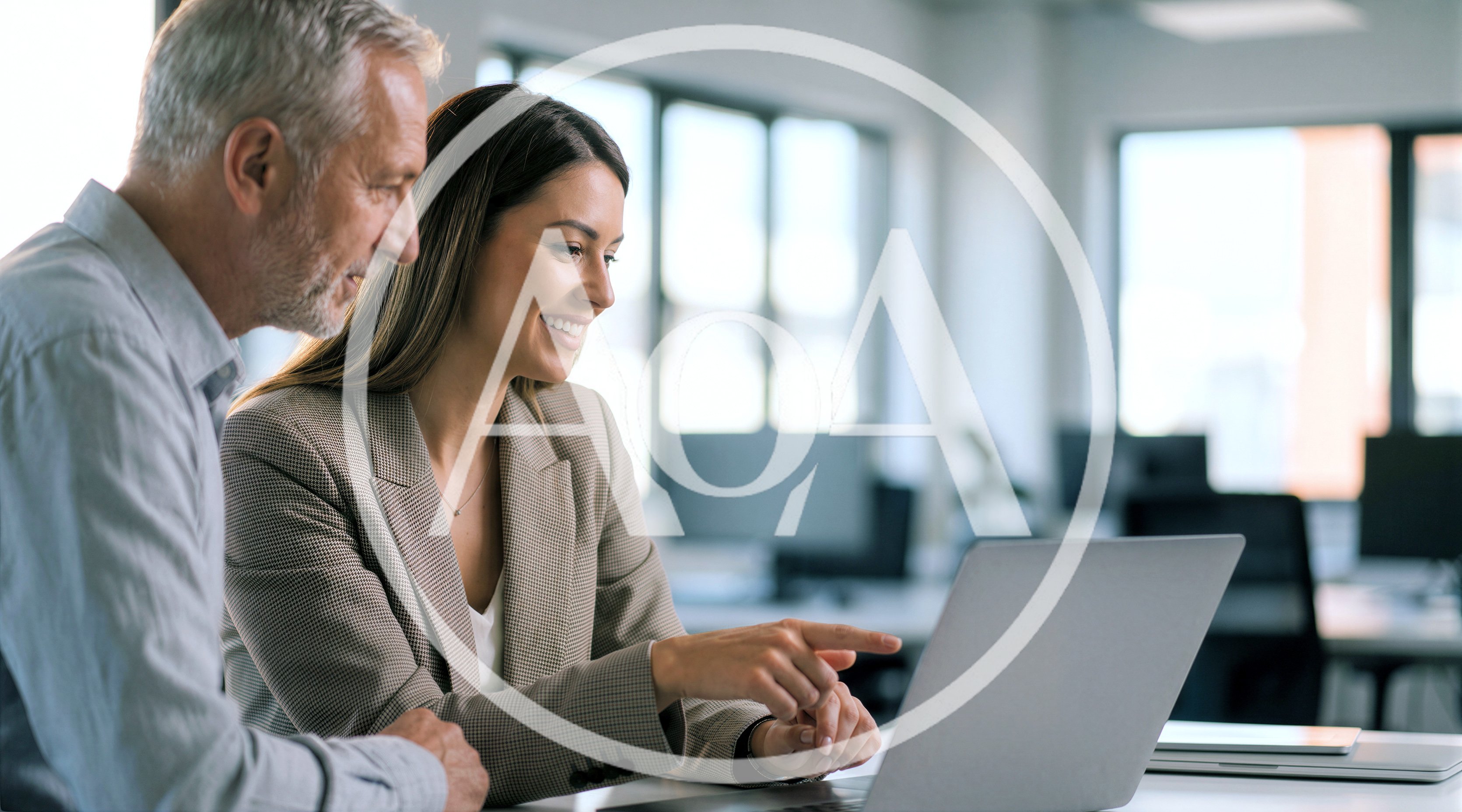 Professional Business Colleagues Collaborating on Laptop in Office
