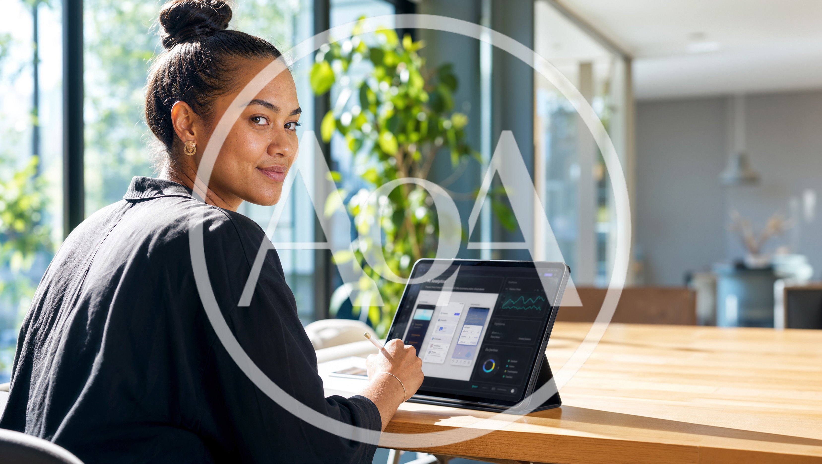 Young Woman Working On Digital Tablet In Bright Office