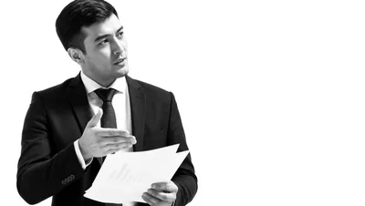 Professional Businessman Presenting Documents In Studio