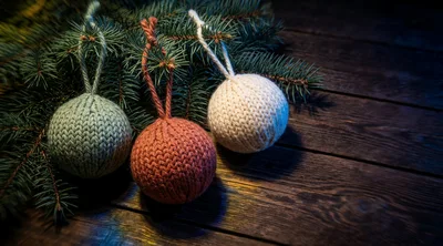 Knitted Christmas Ornaments on Rustic Wooden Background