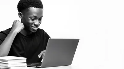 Young Black Man Using Laptop Computer
