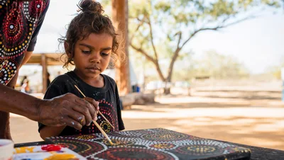 Indigenous Australian Child Painting Dot Art With Elder