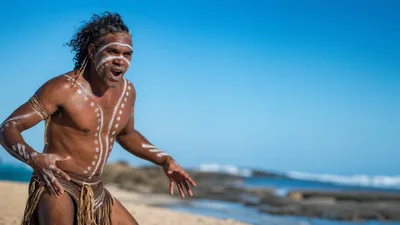 Indigenous Australian Man Performing Traditional Dance On Beach