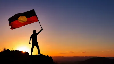 Silhouette Of A Person Holding The Aboriginal Australian Flag