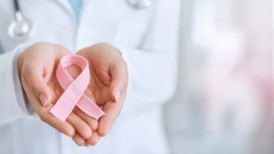 Doctor Holding Pink Breast Cancer Awareness Ribbon