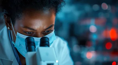 Scientist Examining Samples Through A Laboratory Microscope